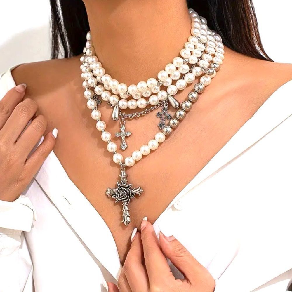 Multi layered pearl cross necklace.